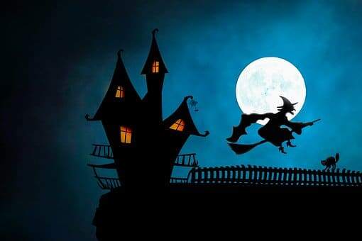 silhouette of haunted house and witch on broomstick